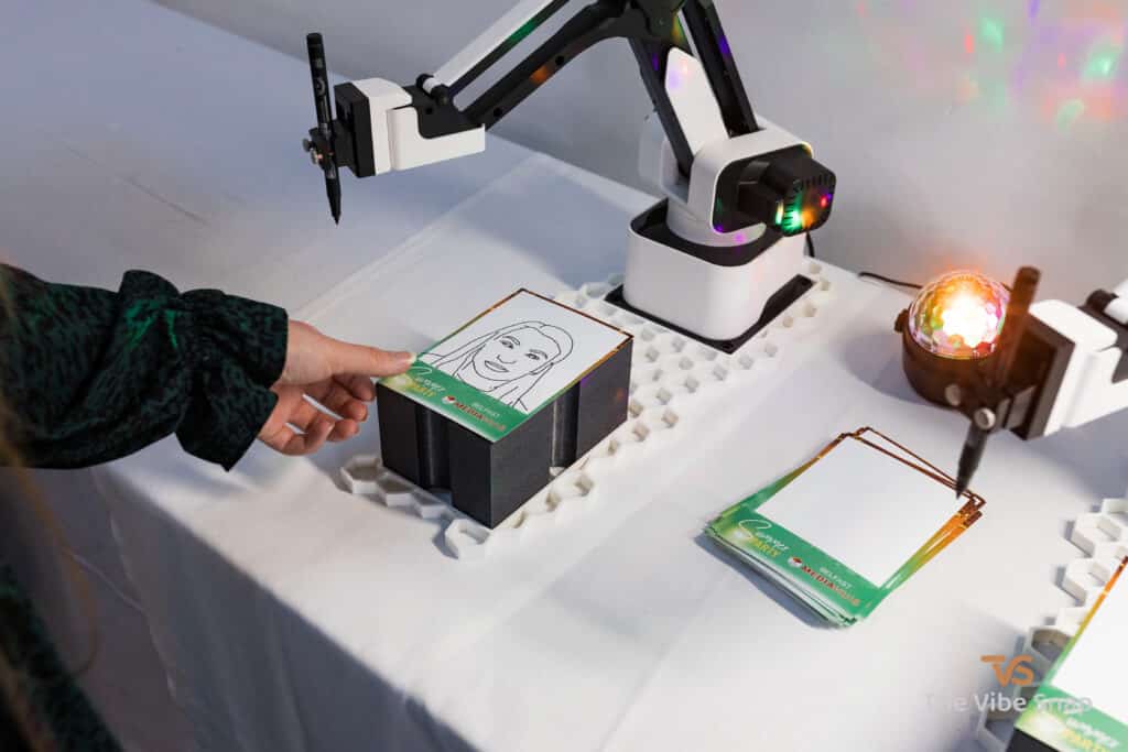 The Sketch Bot doing its thing at a party and sketching guests faces