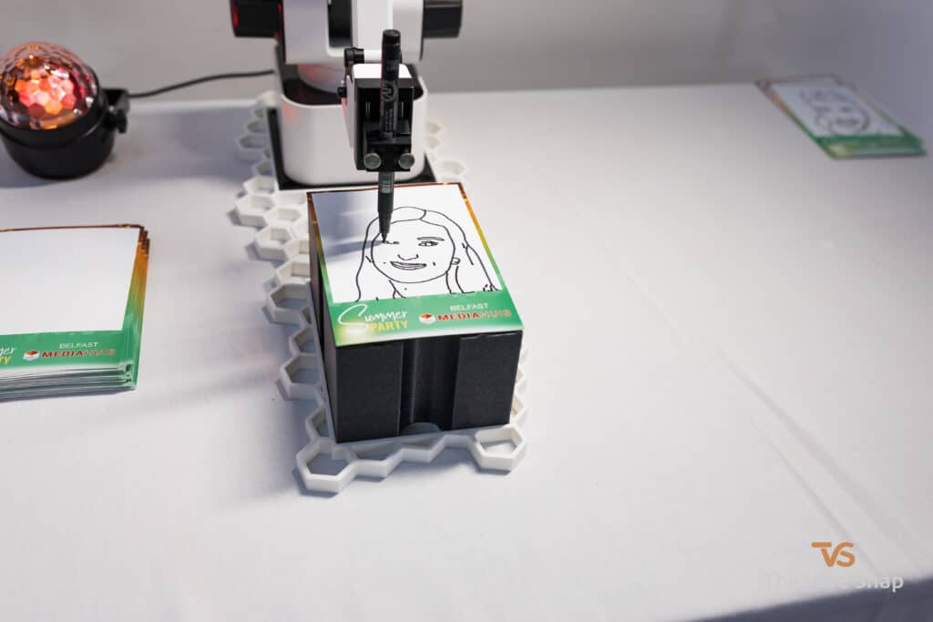 The Sketch Bot doing its thing at a party and sketching guests faces