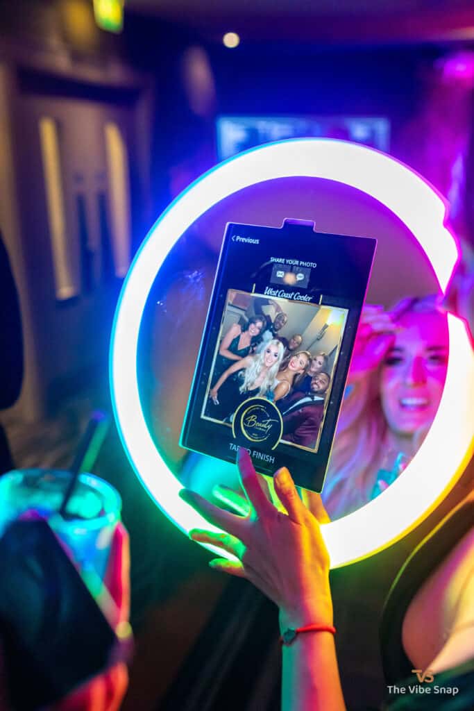Ladies looking at their photo preview on the Roamer booth