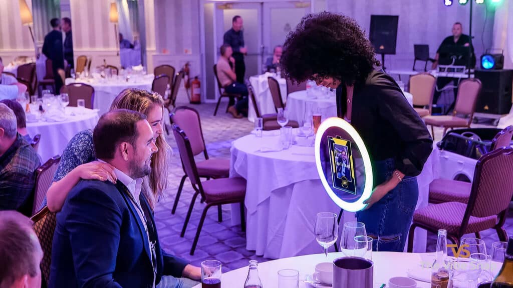 The roamer is getting ready to take photos of a lovely couple at an event