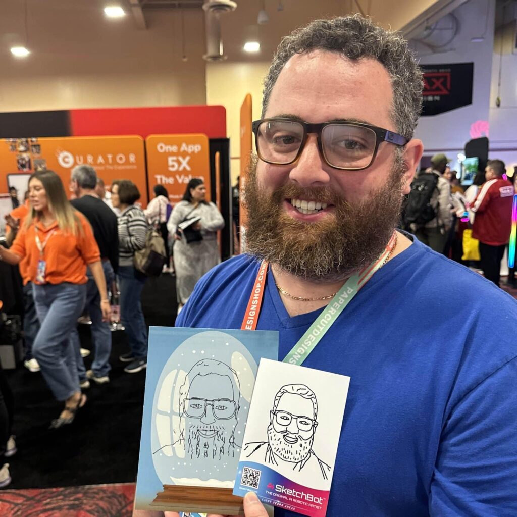 Sketch Bot Rental booth with guests enjoying live sketching portraits.