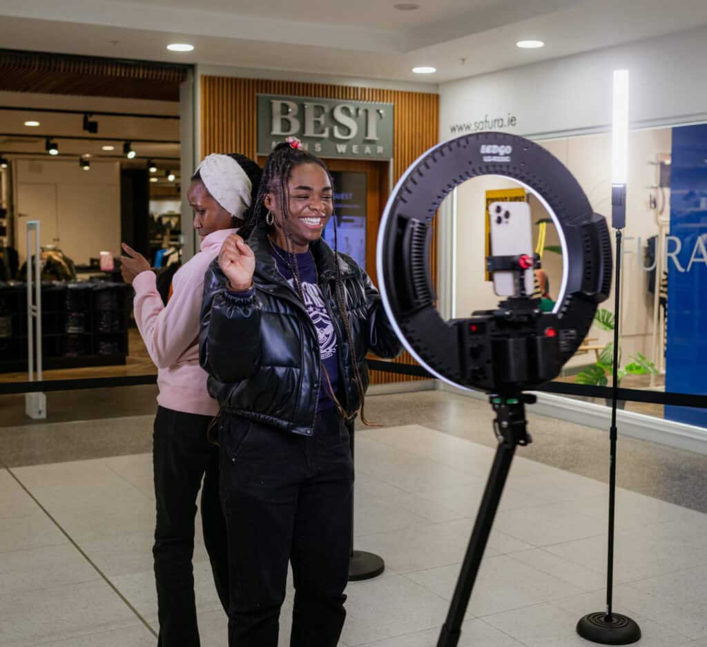 Guests at an event enjoying taking photos on the 360 booth