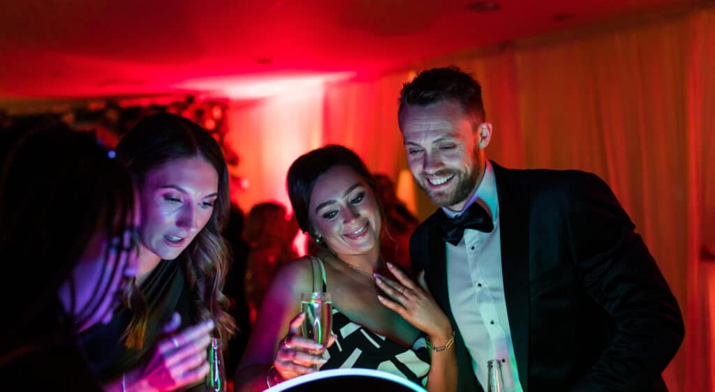 Guests looking at their photos taken on the Roamer Ipad Booth