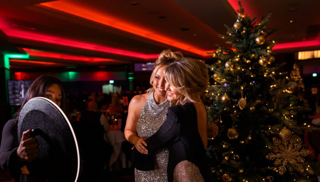 Ladies at a Christmas party getting ready to have their photos taken on the Ipad roamer