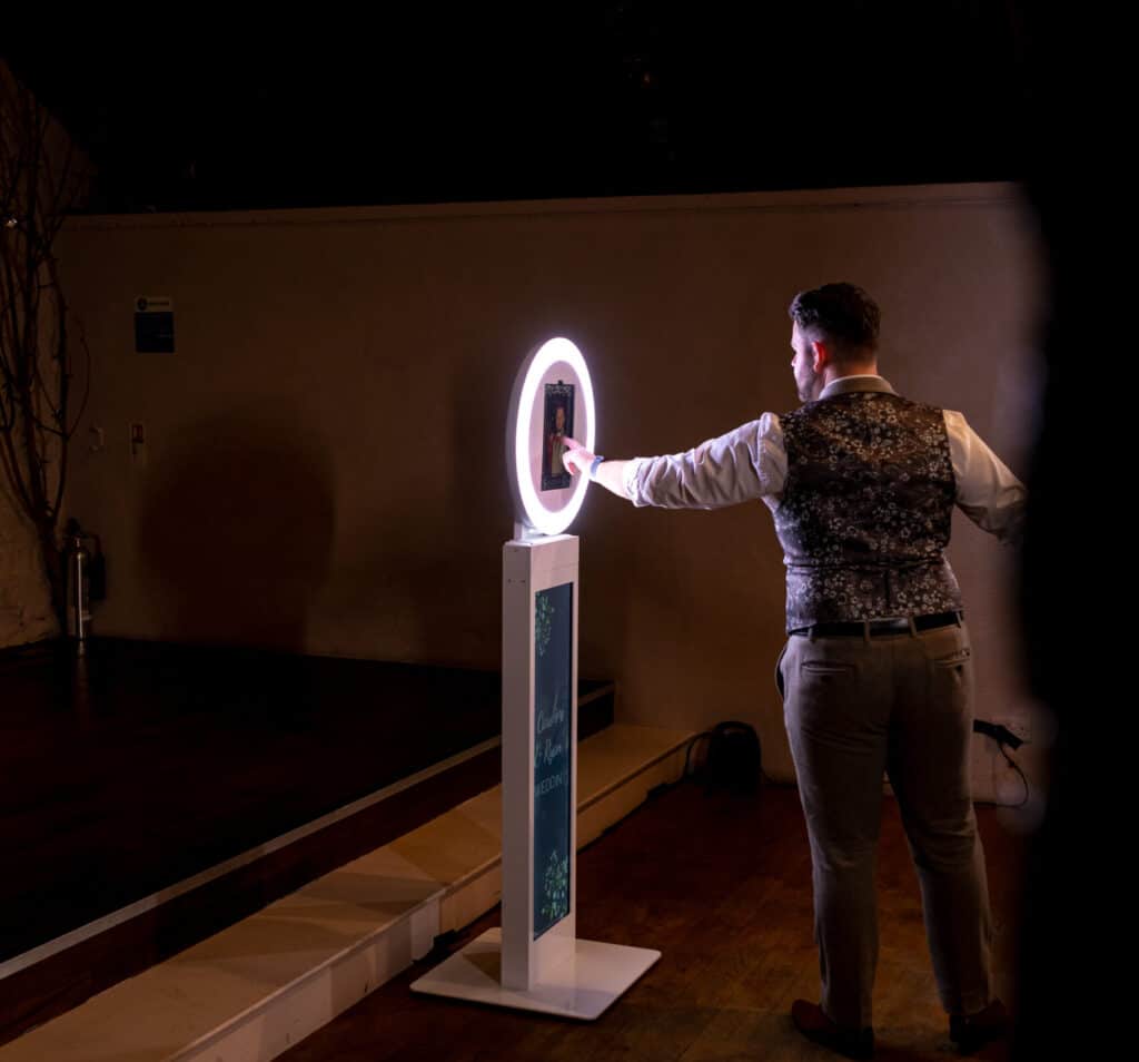 Guests at a wedding getting ready to pose for photos on the Mobi Aura booth
