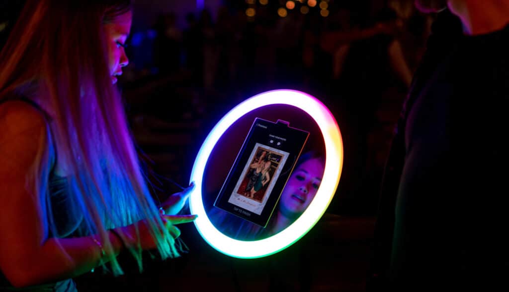 Guests at a wedding getting ready to start putting finishing touches to their photos taken on the Mobi Aura