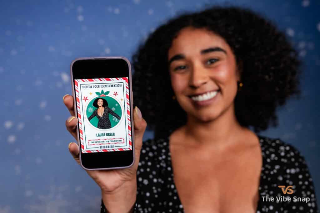 A young woman holding an iphone with her Santas Workshop ID