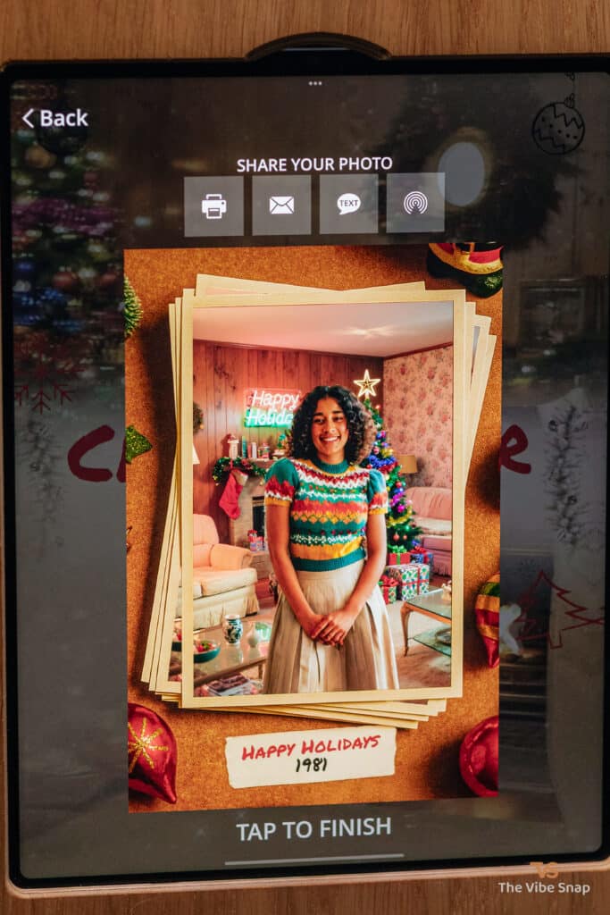 A young woman in a plaid dress with a Happy Holidays frame, transformed into a 1981 holiday scene using a photo booth app, part of the AI Nostalgic Holiday experience