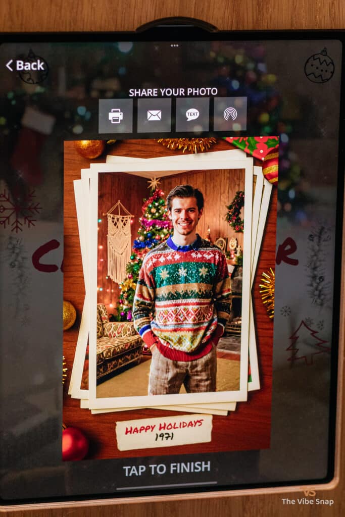 A young man in a festive sweater with a Happy Holidays frame, transformed into a 1971 holiday scene using a photo booth app, part of the AI Nostalgic Holiday experience