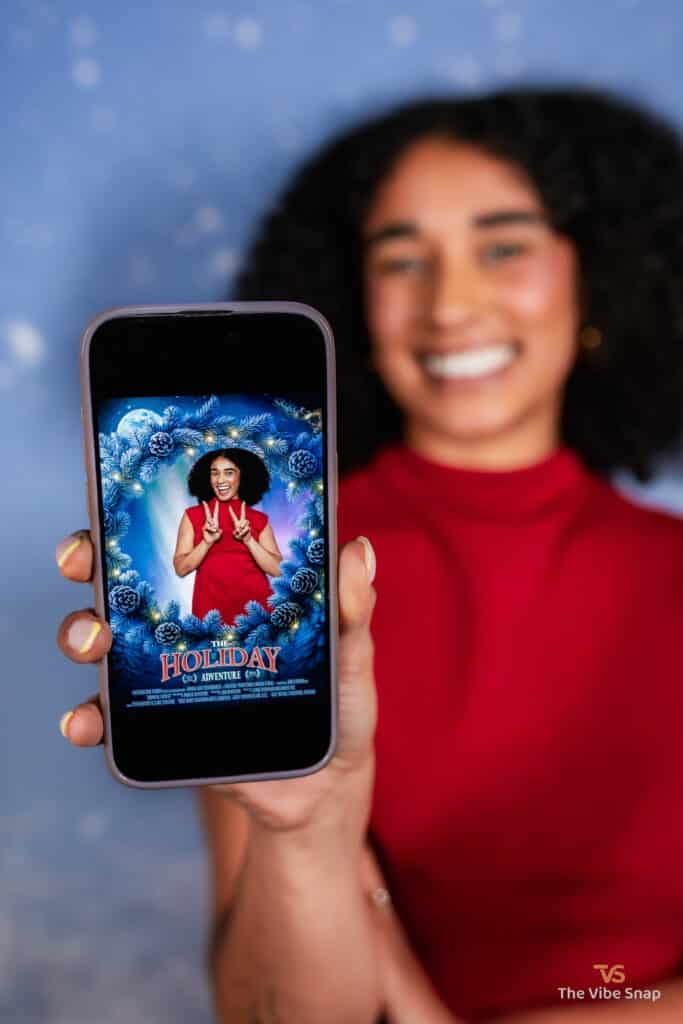 A young woman holding a phone with The Holiday Adventure movie poster