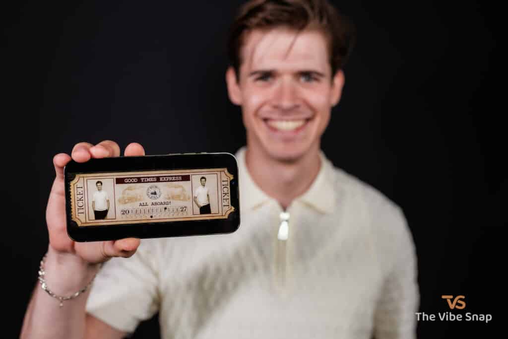 The Wild West Experience - A young man holding an iphone with train ticket photo