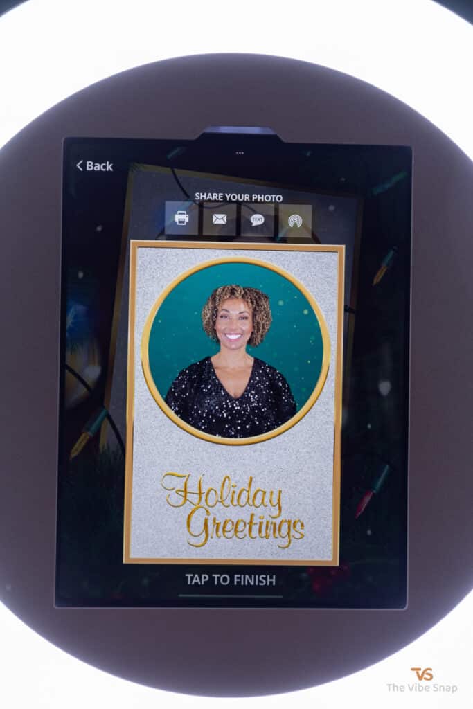 Final photo of mixed race woman showing on ipad booth with sharing options