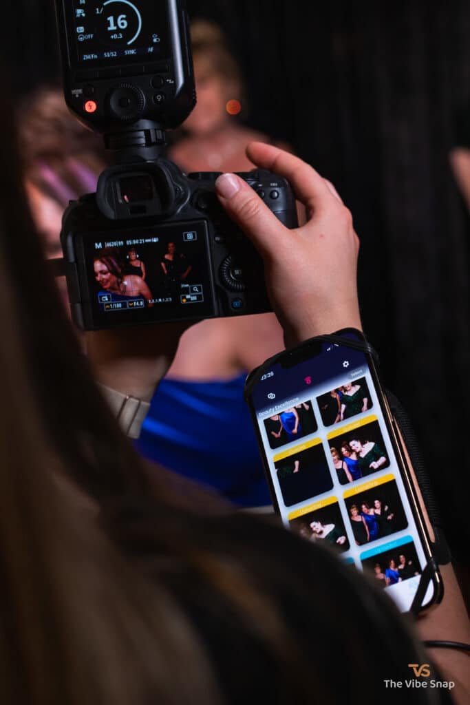 Close-up of the professional camera and iPhone with the most recent photos from the event.